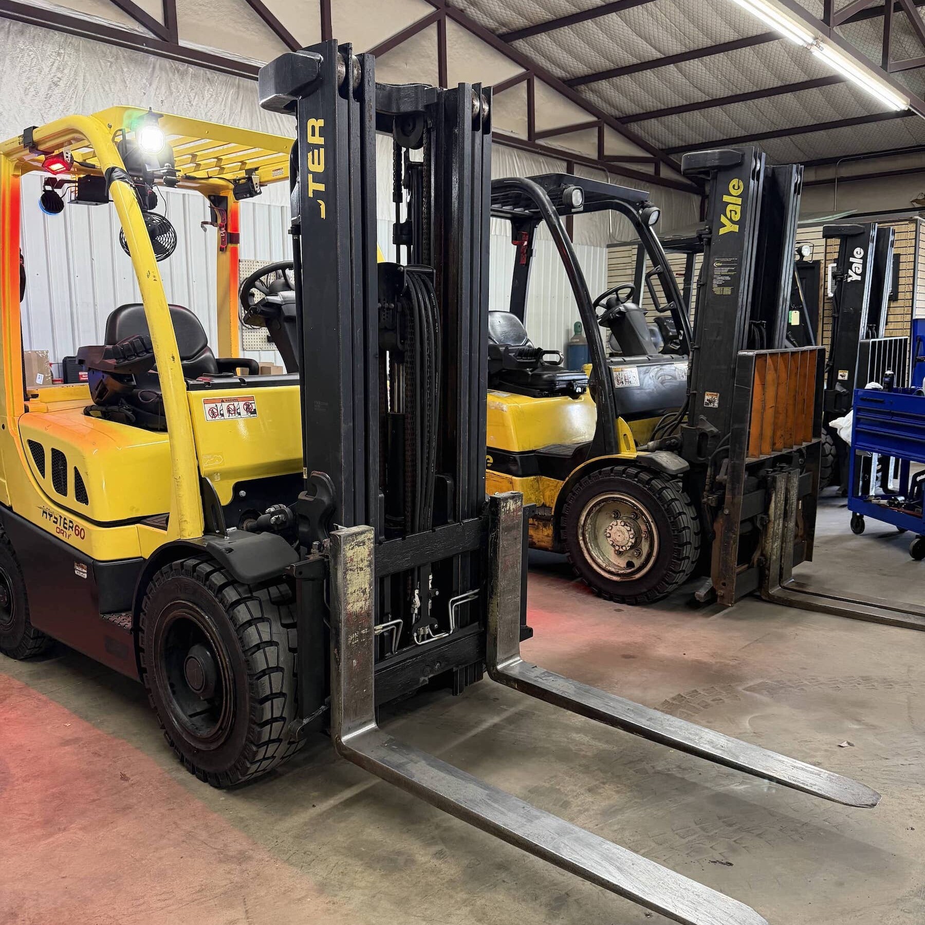 yellow Hyster and Yale forklifts inside a building